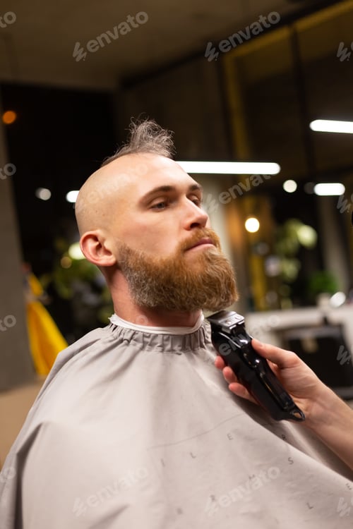 Preview: European brutal man with a beard cut in a barbershop