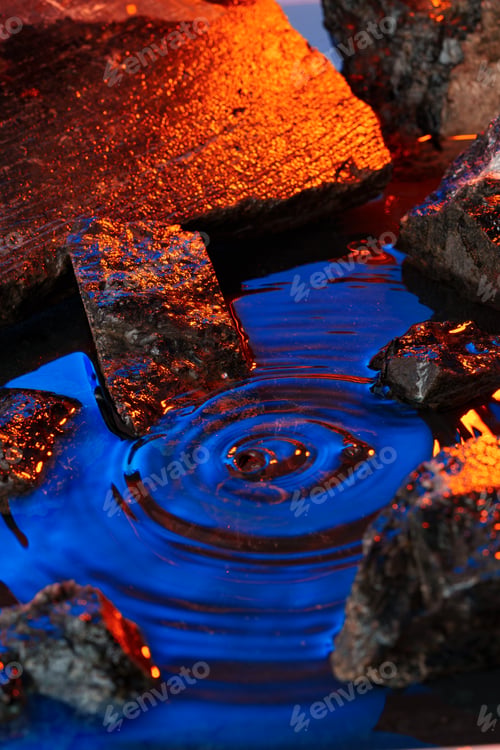 Preview: Stones and water illuminated by colored light