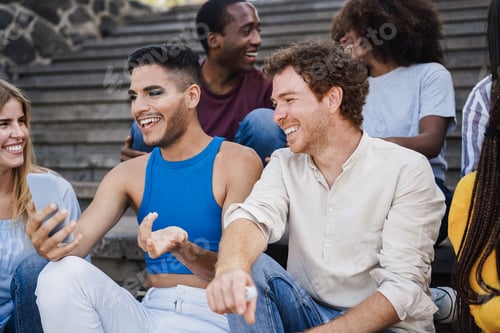 Preview: Young diverse people having fun outdoor laughing together - Focus on right man face