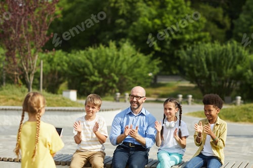 Preview: Kids Applauding Cute Girl in Outdoor Lesson