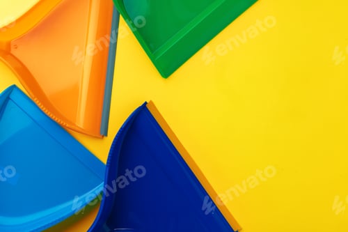 Preview: Four plastic colorful scoops flatlay on yellow background
