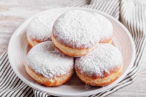 Preview: Berliner doughnuts filled with strawberry jam on white plate