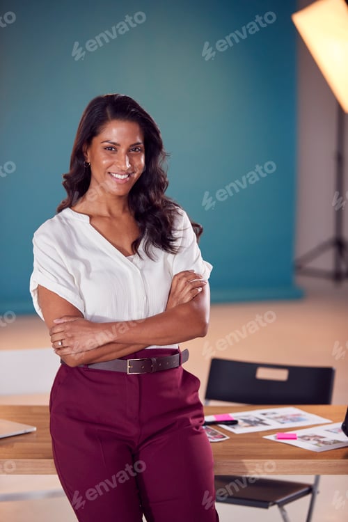 Preview: Portrait Of Mature Female Photographer At Desk In Studio For Fashion Shoot