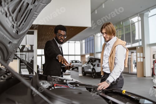 Preview: Young Caucasian male customer and professional African car dealer.