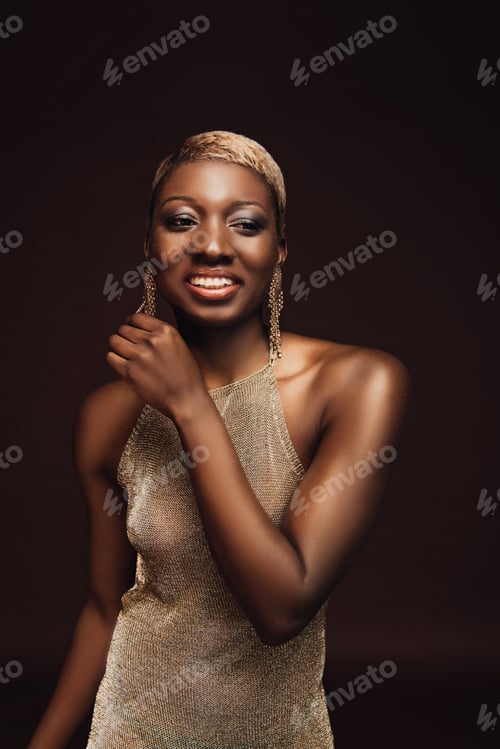 Preview: beautiful cheerful african american woman with short hair isolated on brown