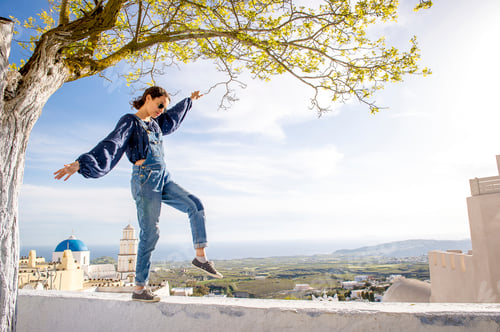 Preview: Girl balancing on top of wall, Oía, Santorini, Kikladhes, Greece