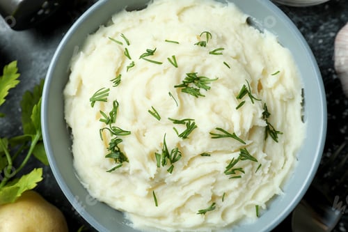 Preview: Concept of tasty eating with mashed potatoes on black smokey table
