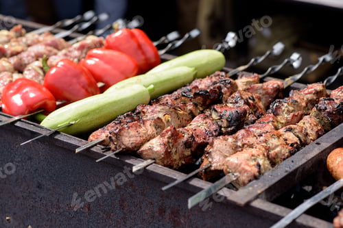 Preview: Grilled meat and vegetables on skewers at a street food festival.