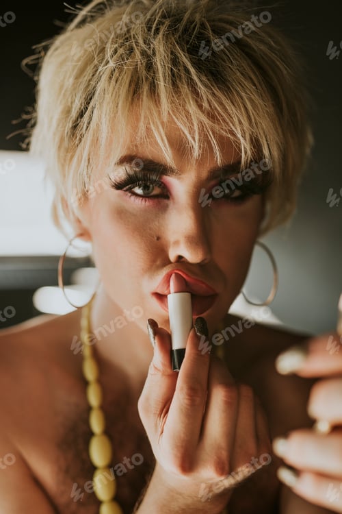 Preview: Man in drag applying lipstick, entertainment makeup look