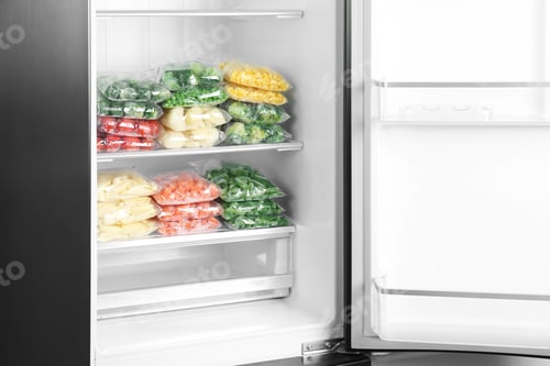 Preview: Plastic bags with different frozen vegetables in refrigerator