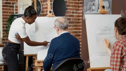 Preview: African american teacher explaining drawing technique to old student