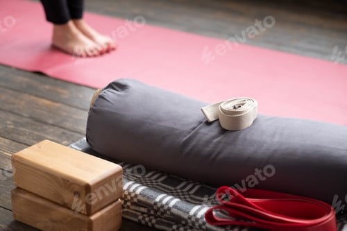 Preview: Caucasian females legs on yoga mat with yoga props