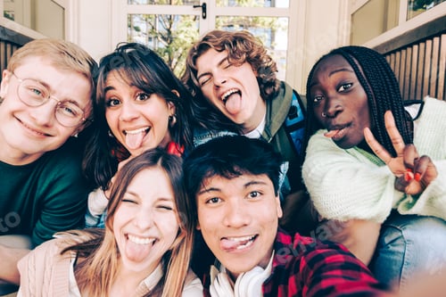 Preview: Group of happy students sticking out tongues and making faces for selfie