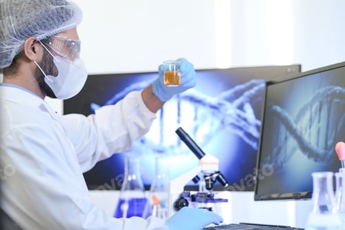 Preview: A clinical laboratory professional in a sterile cleanroom uses a computer to analyze
