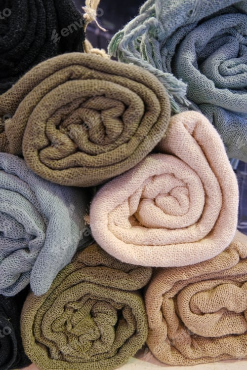 Preview: pile of different pastel colors cotton soft fabric rolls