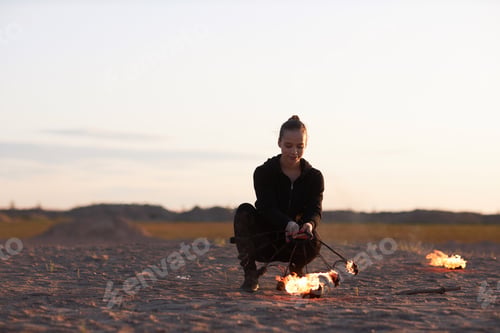 Preview: Woman Holding Fire Fan Preparing for Fire Show