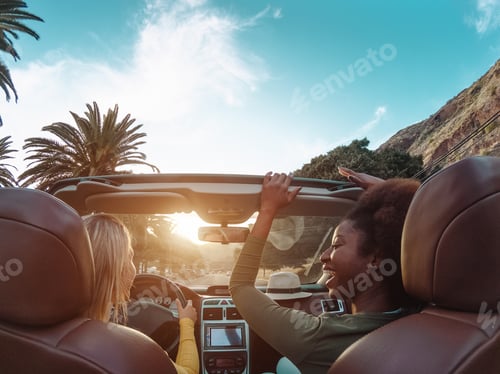 Preview: Young happy women doing a road trip in tropical city