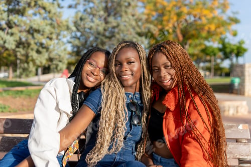 Preview: Young black women friends smiling enjoying park time