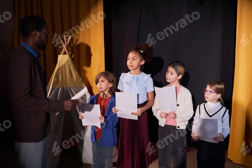 Preview: Kids Listening to Drama Teacher Rehearsing School Play