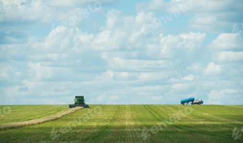 Preview: modern combine harvester working on a wheat crop, panorama