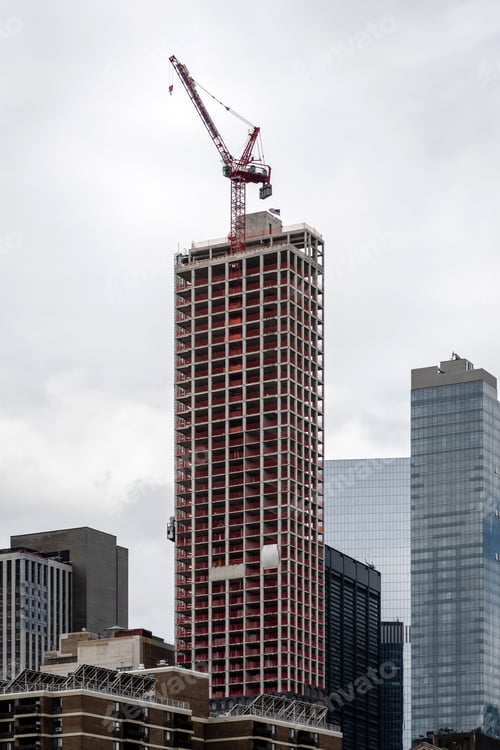 Preview: Skyscraper construction site with crane against cloudy sky, New York City, USA
