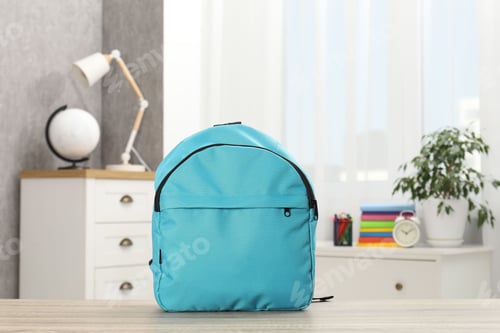 Preview: Light blue backpack on desk in room