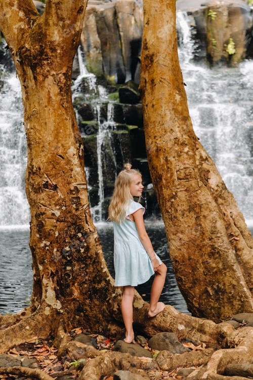 Preview: A little girl stands near the Rochester Waterfall on the Island of Mauritius.A waterfall in the