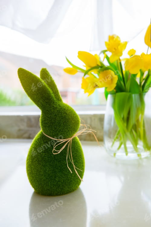 Preview: Cute green grass bunny rabbit and bouquet of fresh spring yellow tulips and daffodils flowers