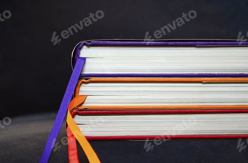 Preview: Closeup of the three hardcover books on the black surface