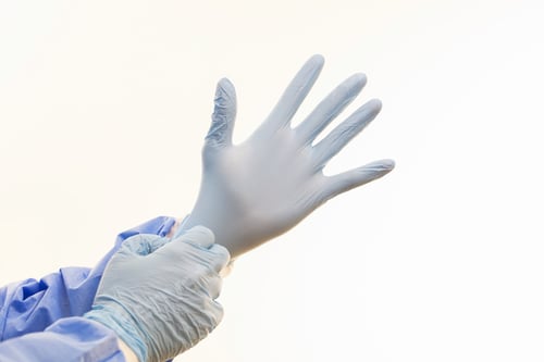 Preview: Gloved Hands Preparing for Medical Procedure