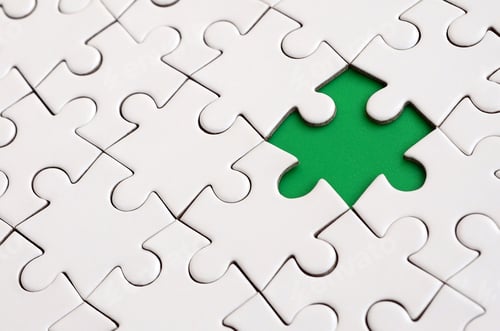 Preview: Close-up texture of a white jigsaw puzzle in assembled state with missing elements