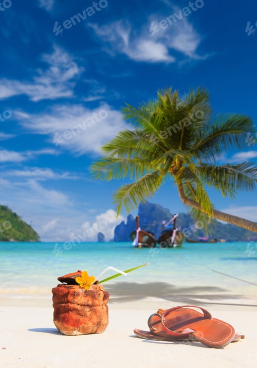 Preview: Coconut cocktail with drinking straw and sandals