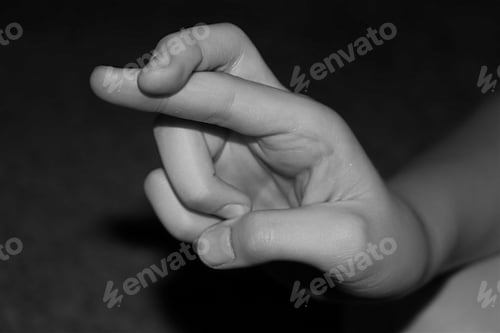 Preview: Monochromatic conceptual image of human hand crossing fingers.