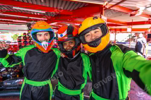 Preview: Smiling Friends in Racing Suits Wearing Protective Helmets