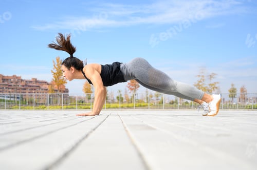 Preview: Sports girl doing exercises on the floor in the street