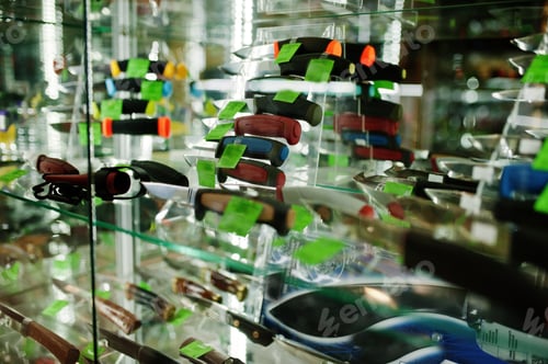 Preview: Different small knifes on shelves store weapons on shop center.