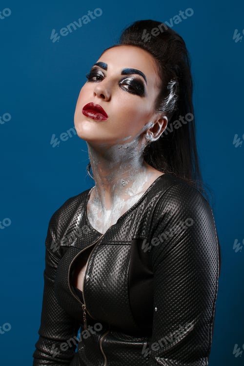 Preview: Girl With Creative Make-Up On A Blue Background