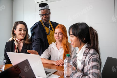 Preview: Business people work on laptop during a meeting, multi ethnic group