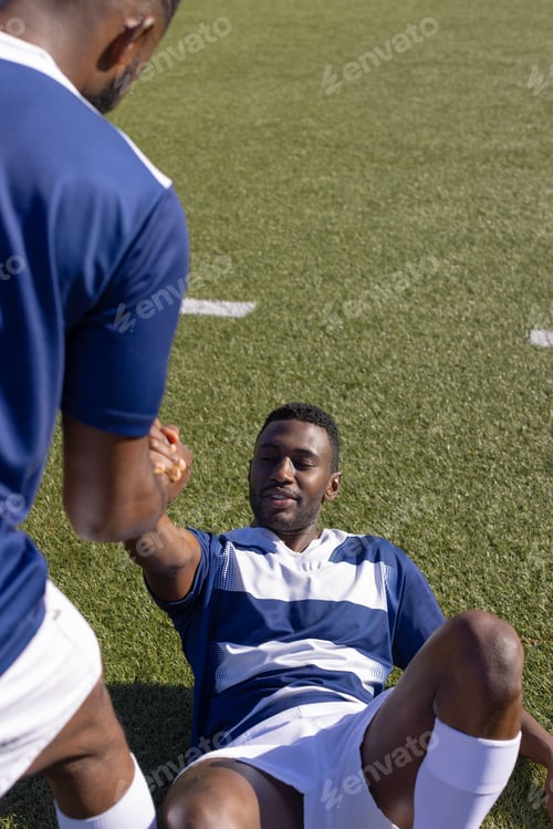 Preview: Two African American young male athletes are training on field outdoors, copy space