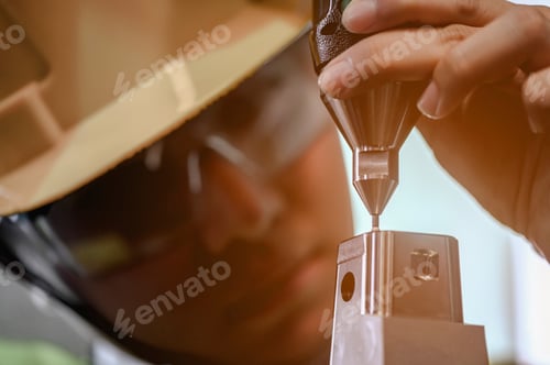 Preview: Young engineer is using a CNC machine to check the size, check the size of 3D