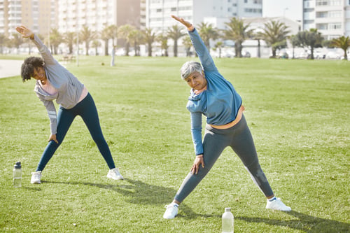 Preview: Women, elderly and stretching in park, exercise and wellness with flexibility and start workout out