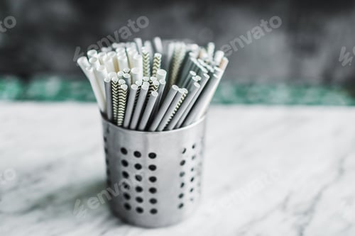 Preview: Set of different paper drinking straws on gray concrete background in cafe close-up. Recycling