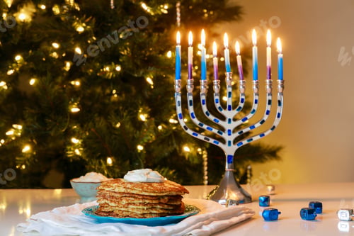 Preview: Hanukkah menorah and crispy potato latkes for Jewish holiday dinner.