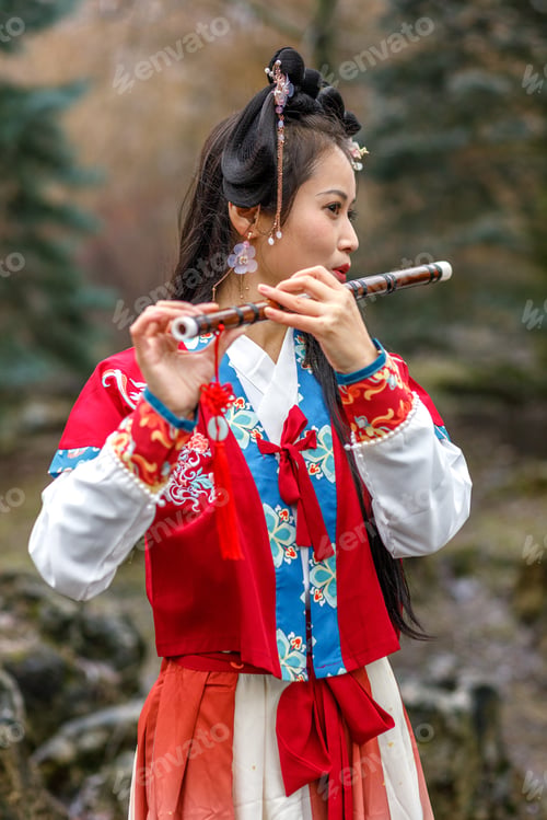 Preview: A Asian woman in traditional red Chinese costume walks,plays the bamboo flute.Chinese New Year