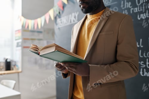 Preview: Teacher reading textbook at lesson