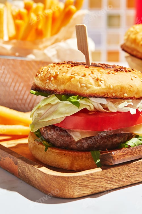 Preview: Delicious homemade burgers on wooden tray in bright sunlight. Burgers with veal cutlet, pamidor
