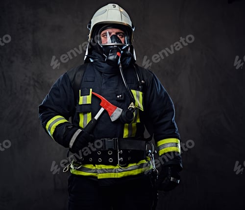 Preview: Firefighter dressed in a uniform holds a red axe.