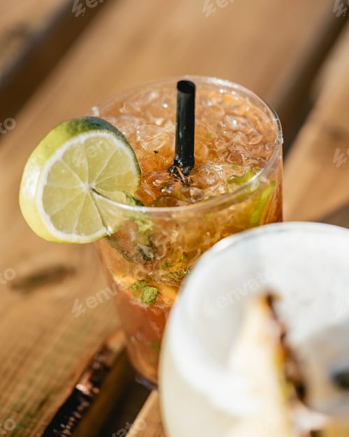 Preview: Vertical shot of cocktail glasses with lime