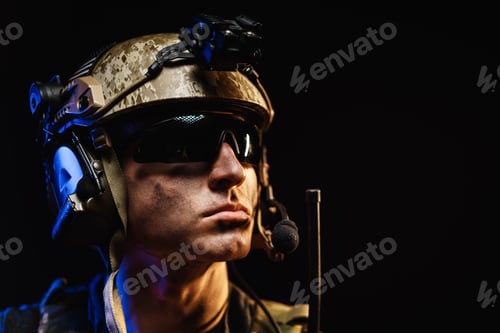 Preview: Portrait of special forces soldier in helmet and glasses in the dark