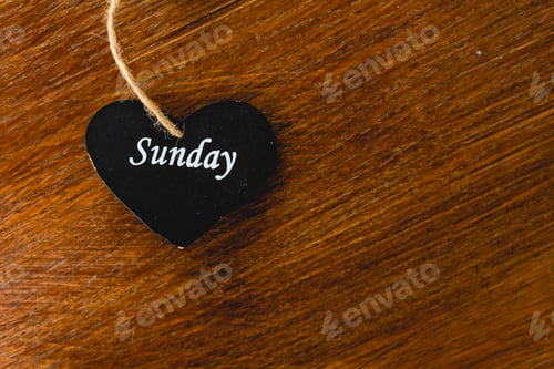 Preview: Black wooden heart with day of the week written on it, Sunday.